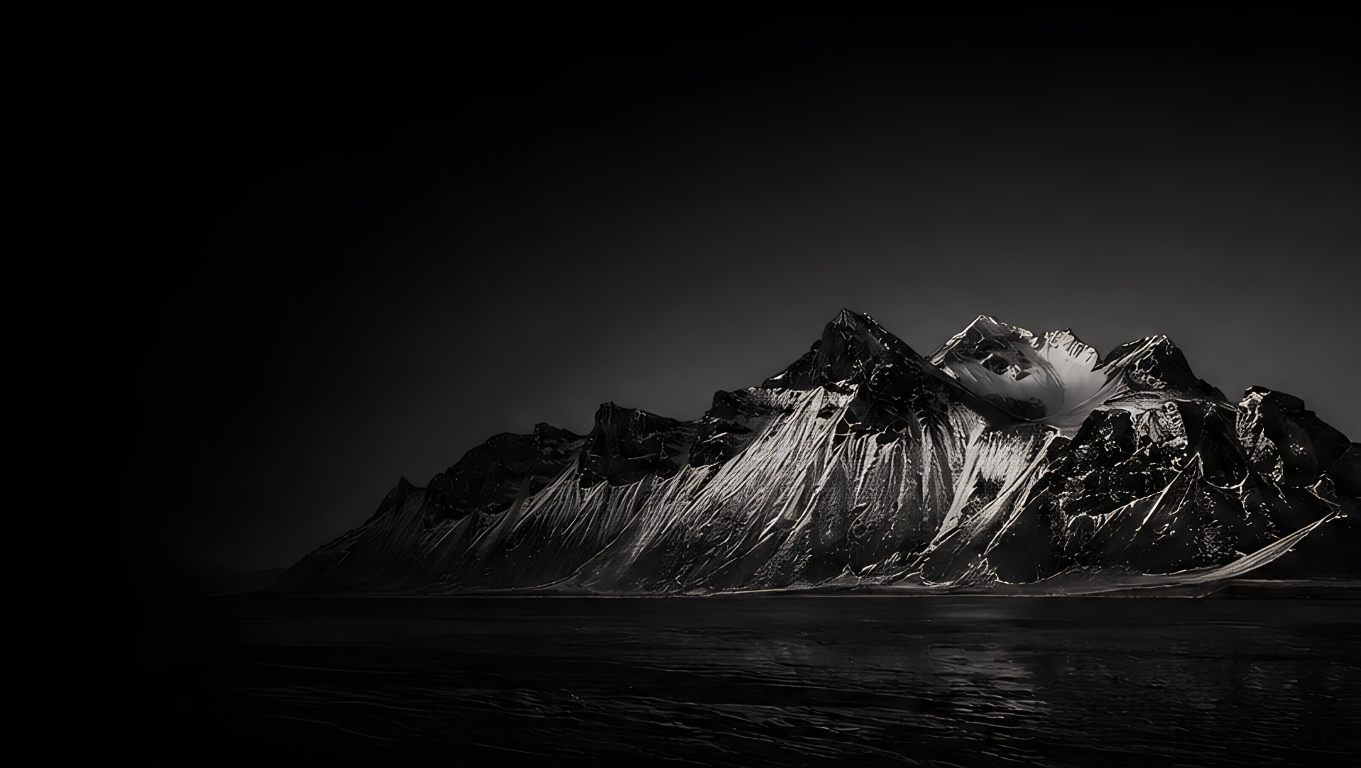 Monochrome mountain range rising from still water